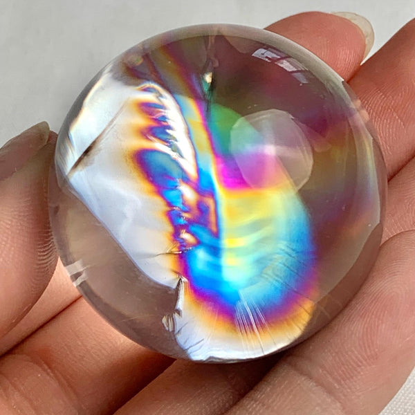 Polished rainbow quartz crystal ball measuring 37mm diameter