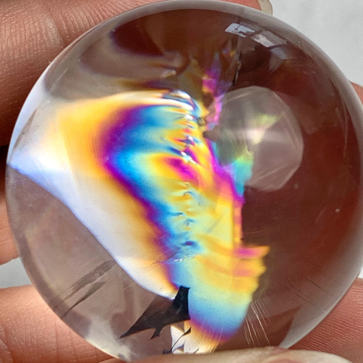 Collector quality rainbow quartz sphere weighing approximately 75 grams