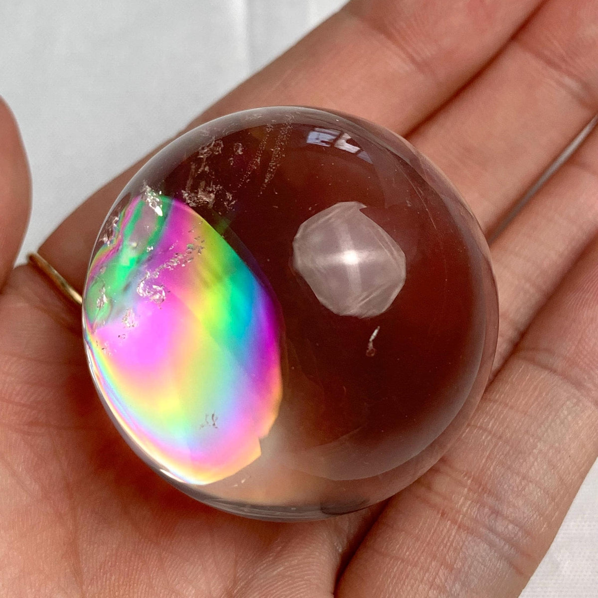 Rare collector rainbow quartz crystal sphere showing vivid light-reflecting rainbow fractures