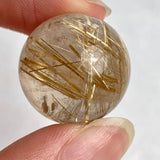 High grade rutilated quartz sphere with dense golden needle inclusions