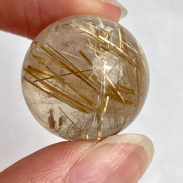 High grade rutilated quartz sphere with dense golden needle inclusions