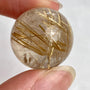 High grade rutilated quartz sphere with dense golden needle inclusions