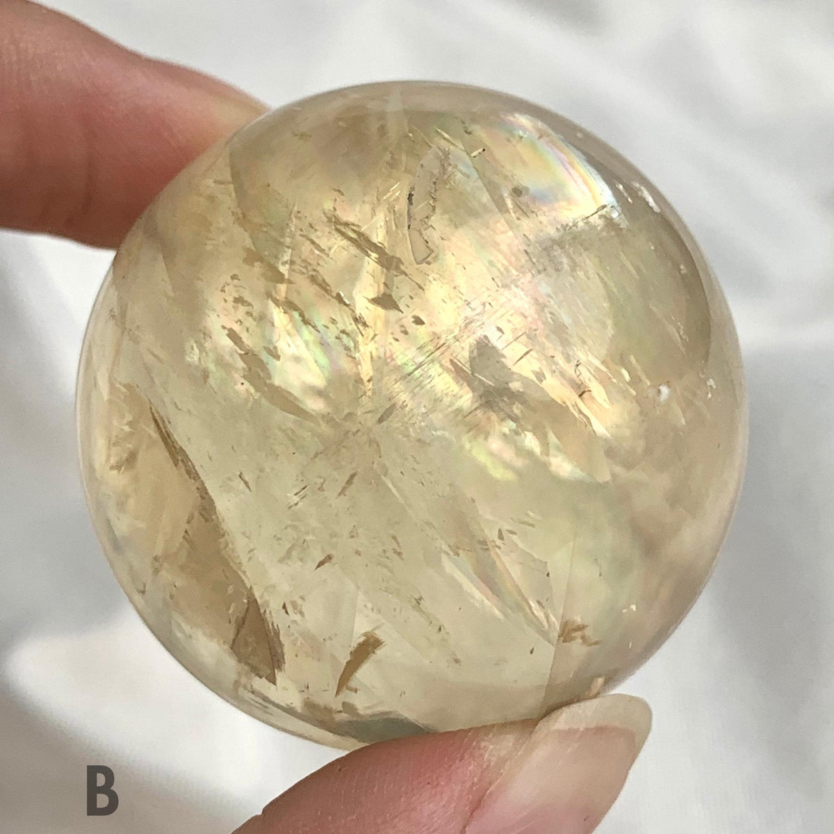 Natural gemstone sphere with colorful reflections
