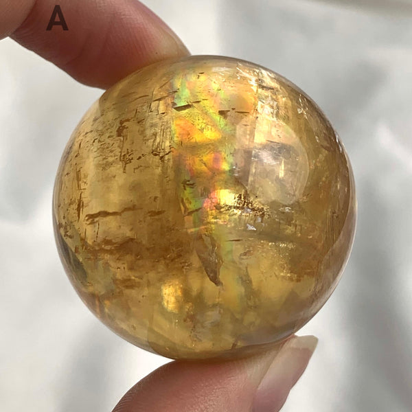 Rainbow calcite crystal ball display