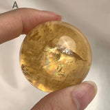 Natural calcite sphere with golden yellow tones