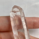 Compact natural quartz specimen measuring 62mm long