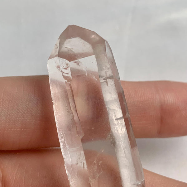 Compact natural quartz specimen measuring 62mm long