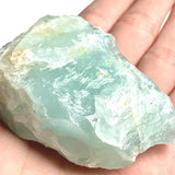 Large rough aquamarine crystal displayed on a white background