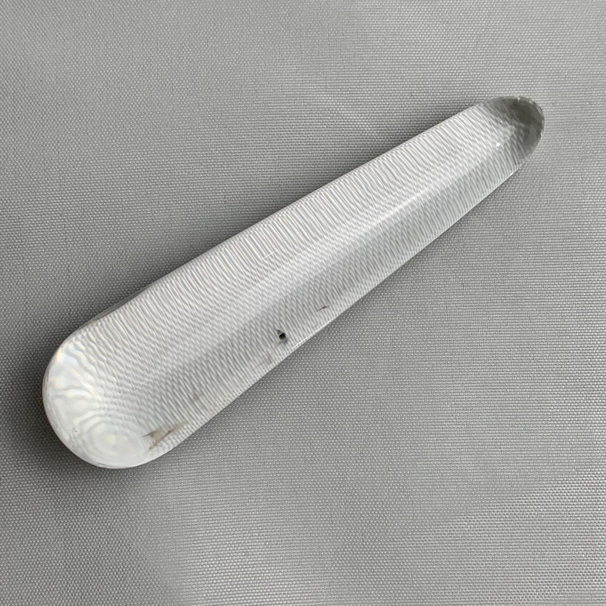 polished acupressure tool made of clear quartz