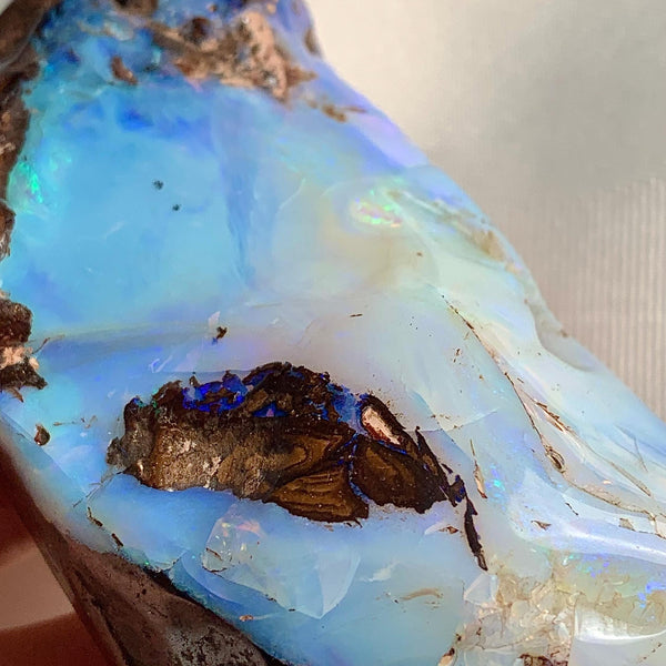 Natural boulder opal specimen showing iridescent colors