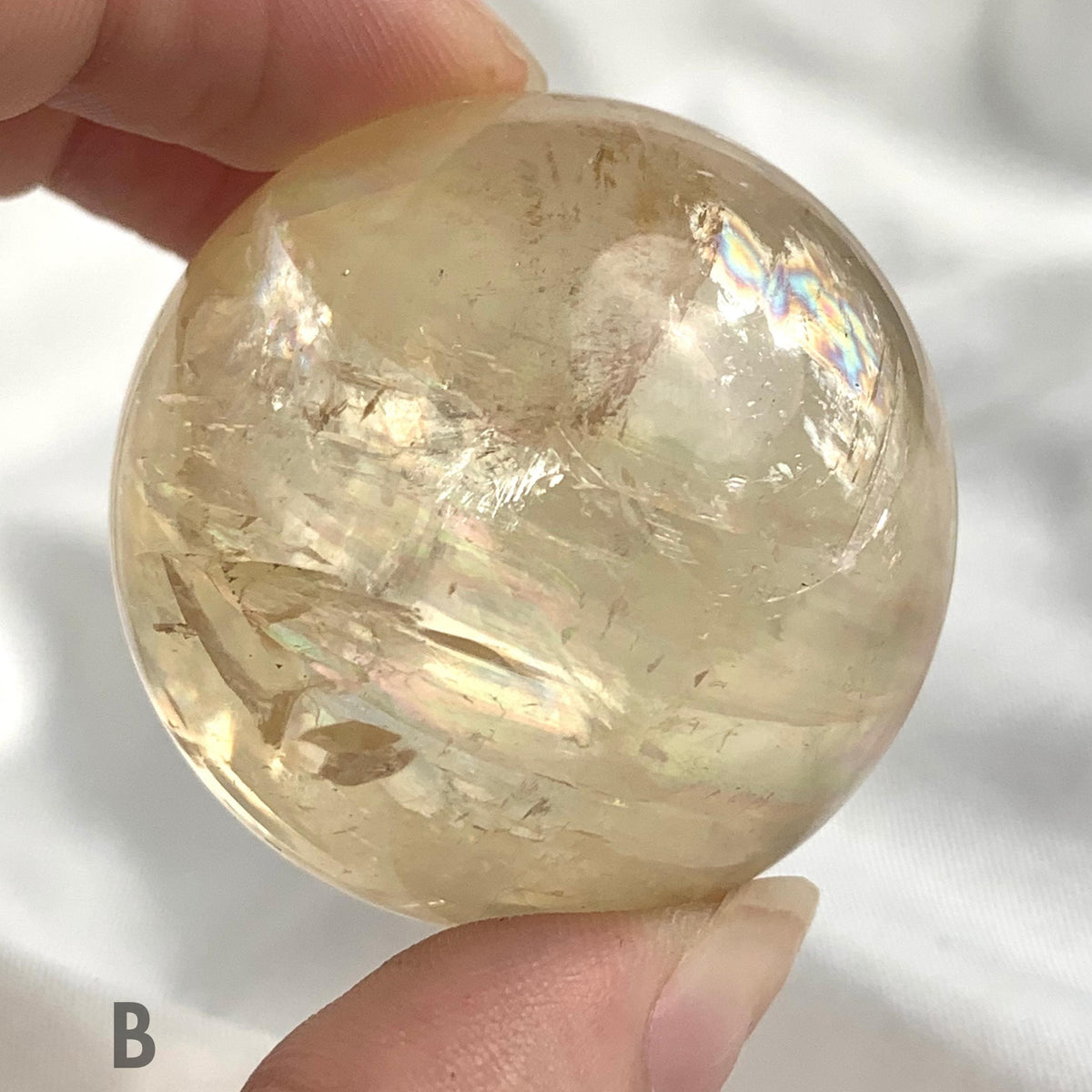 Golden calcite crystal sphere close up view
