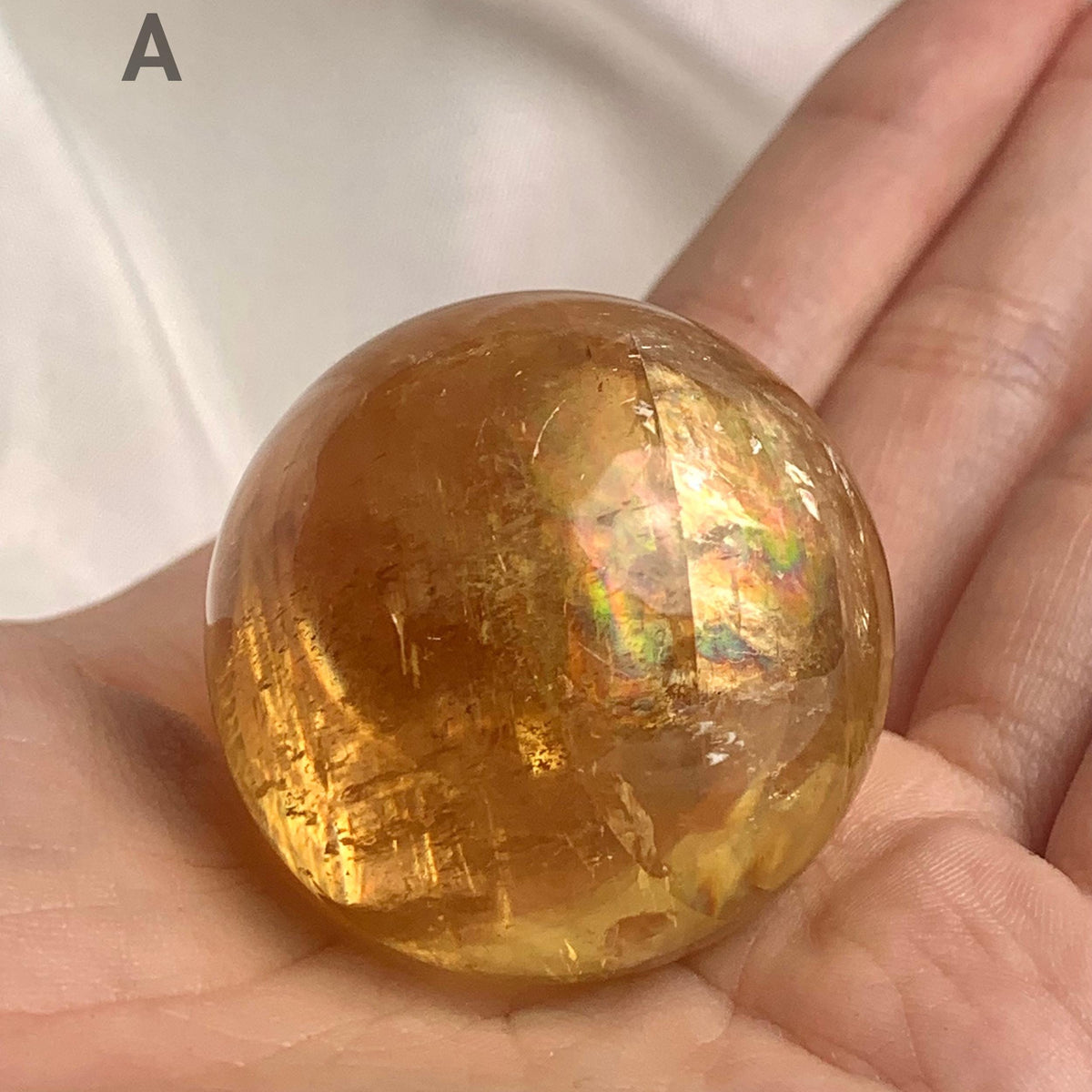 Rainbow inclusion honey calcite gemstone sphere