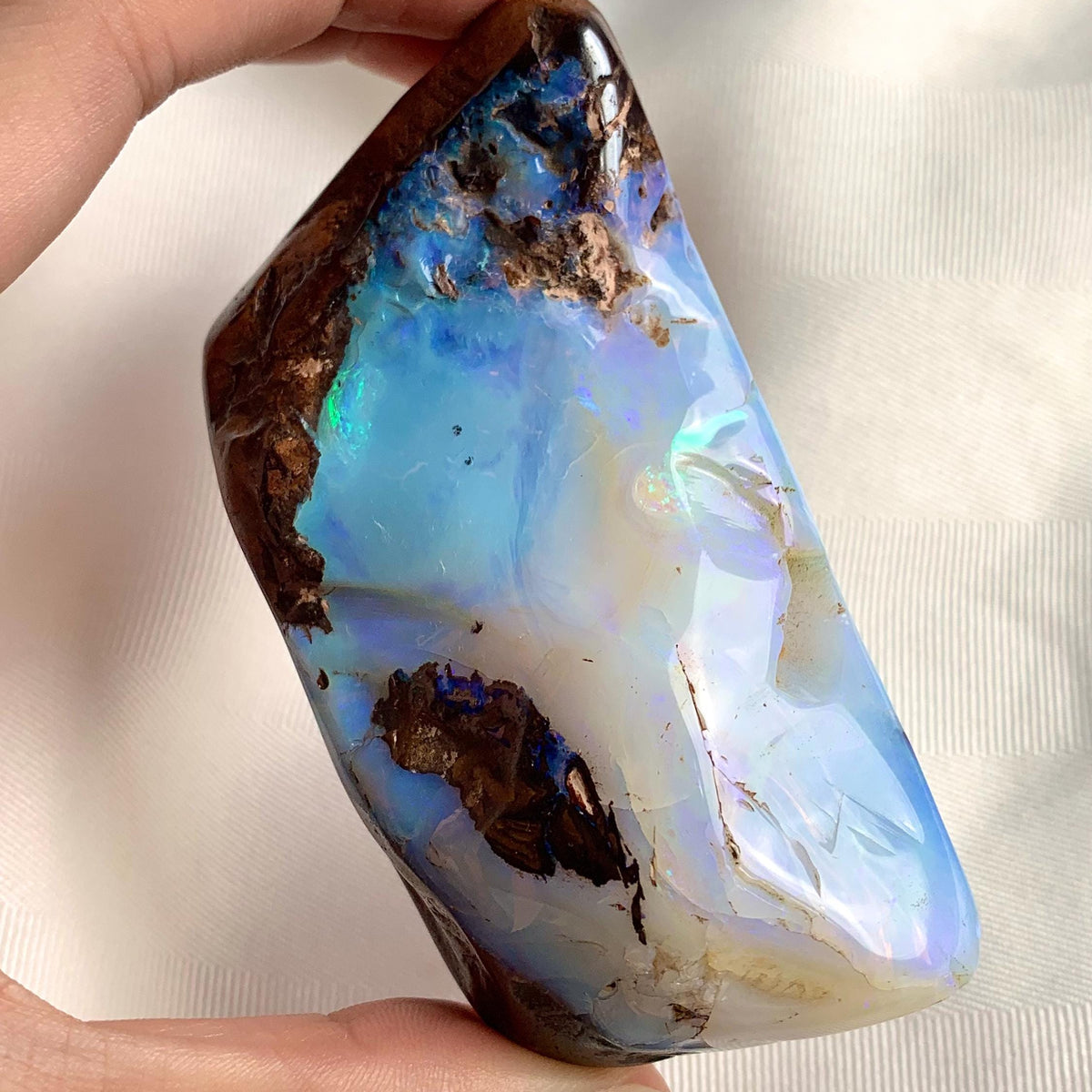 Raw Australian boulder opal with vivid blue green flash