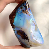Raw Australian boulder opal with vivid blue green flash
