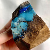 Raw Australian boulder opal with blue green iridescent flashes