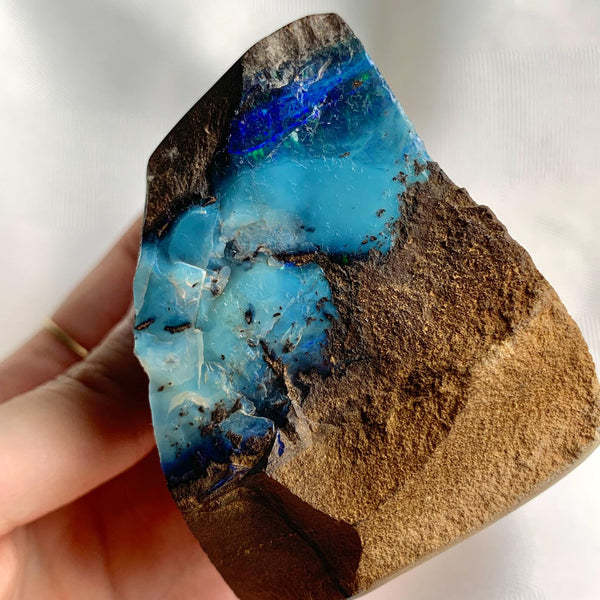 Raw Australian boulder opal with blue green iridescent flashes