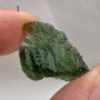 Raw Moldavite stone displaying natural etched surface details