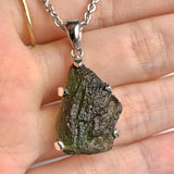 Natural Czech moldavite pendant showing raw texture and form