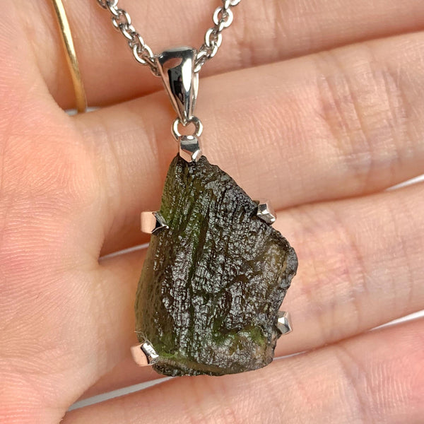 Natural Czech moldavite pendant showing raw texture and form