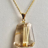 Faceted trapezoid Rutilated Quartz necklace showing natural golden rutile threads
