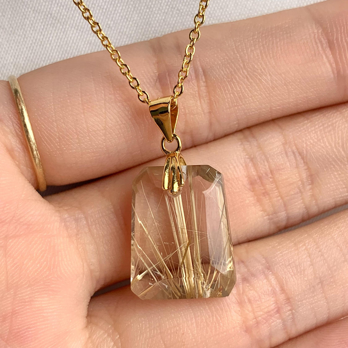 AAAA Rutilated Quartz pendant with prominent golden rutile needles