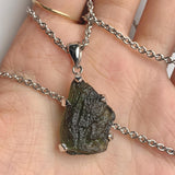 Authentic raw moldavite crystal pendant close up view