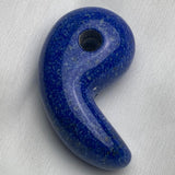 Polished 60mm Lapis Lazuli magatama carving on a white background