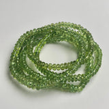Green peridot bracelet showcasing smooth 5mm rondelle gemstone beads.