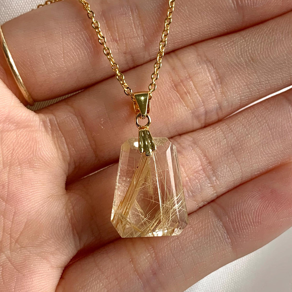 Natural faceted AAAA Rutilated Quartz pendant with brilliant golden inclusions