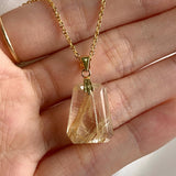 Natural faceted AAAA Rutilated Quartz pendant with brilliant golden inclusions