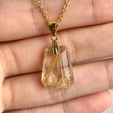AAAA Rutilated Quartz pendant with prominent golden rutile needle inclusions