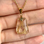 AAAA Rutilated Quartz pendant with prominent golden rutile needle inclusions