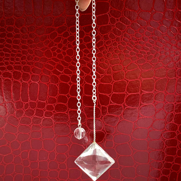 AAAA flawless clear quartz pendulum with a faceted design hanging from an 8-inch sterling silver chain.