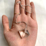 Small clear quartz dowsing pendulum with geometric faceted surface