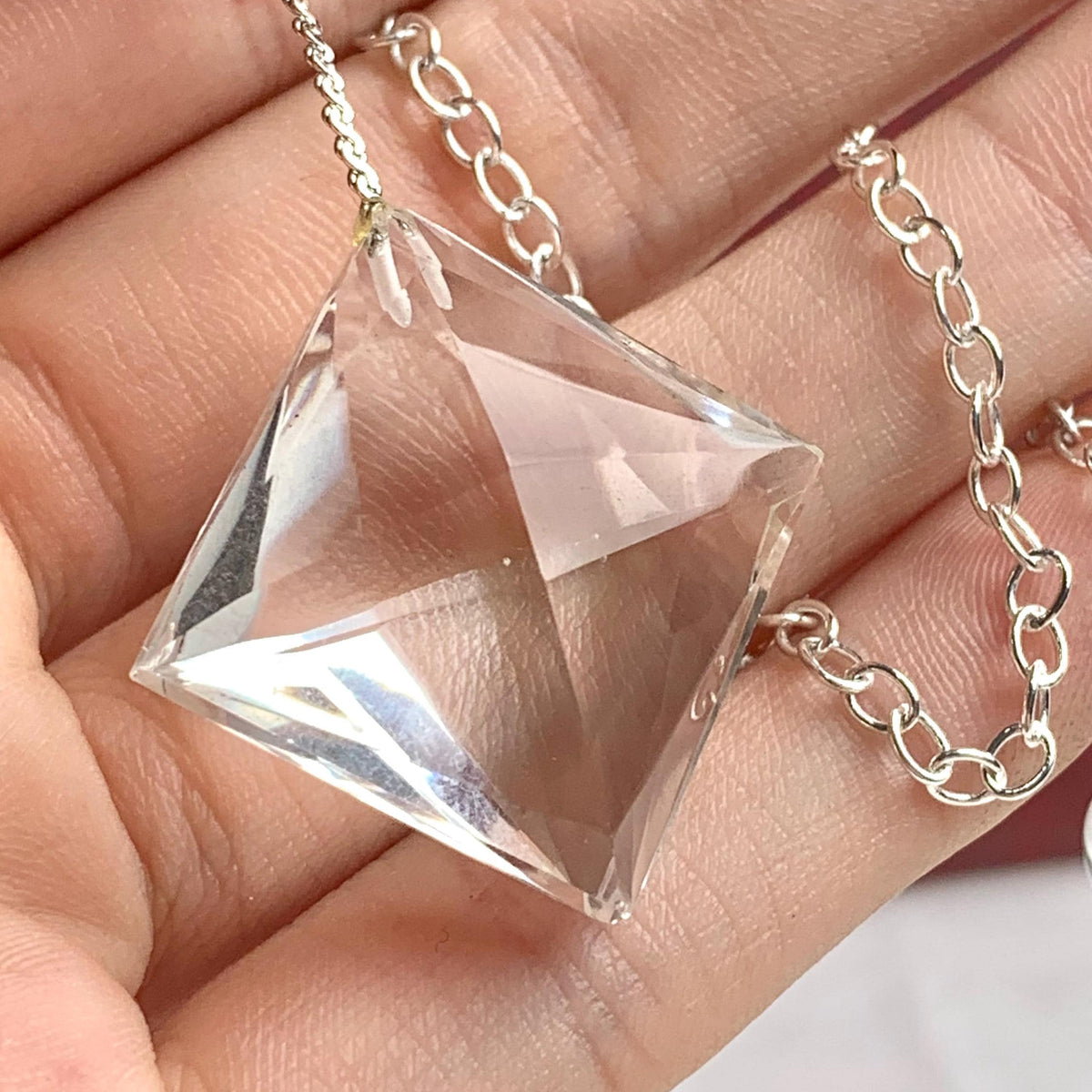 2.	Close-up of water-clear faceted quartz crystal 20mm wide showing pristine internal clarity and crisp gem facets.