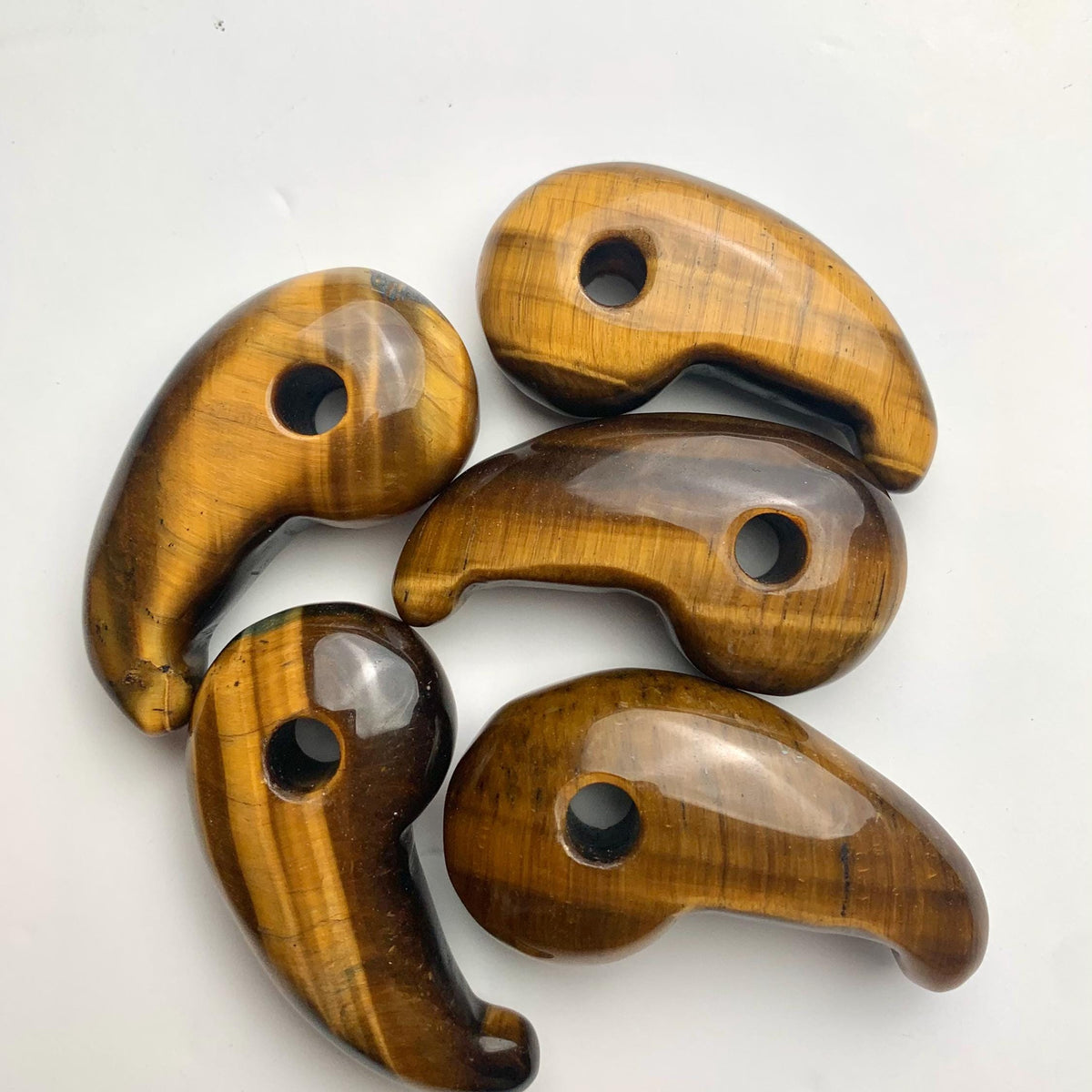 polished curved Tiger Eye gemstone magatama focal bead