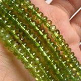 Close-up of 5mm peridot beads in a smooth rondelle shape