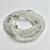 Faceted rainbow moonstone beads arranged as a blue gemstone bracelet