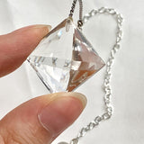 Clear quartz crystal pendulum shown with its 200mm chain