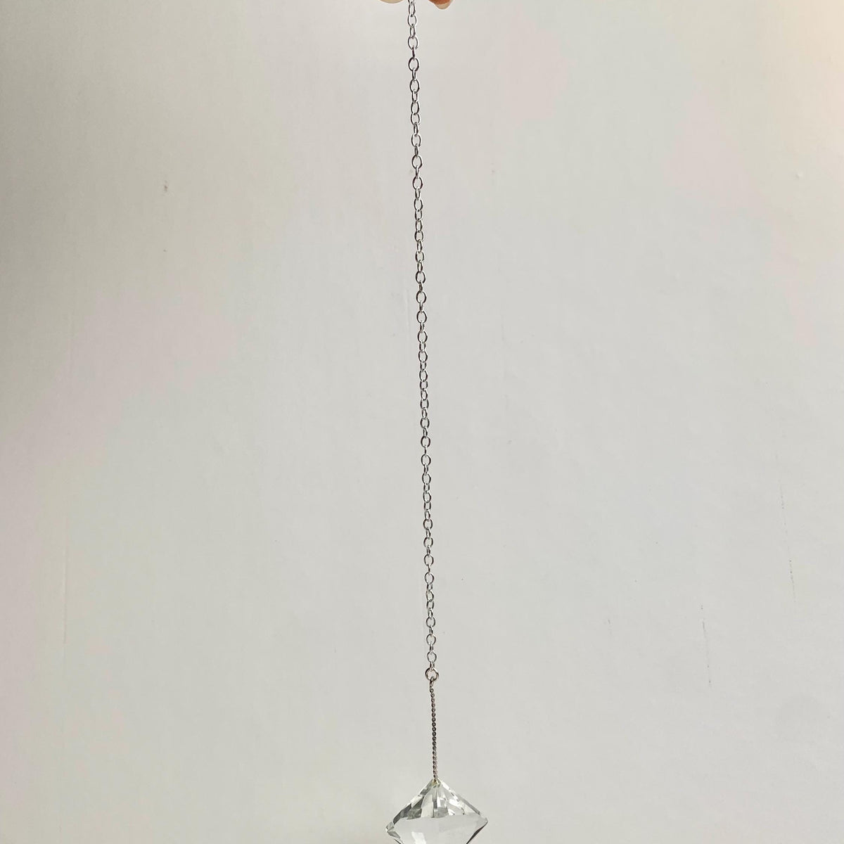 Faceted crystal pendulum with attached chain for crystal collectors