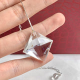 Clear quartz crystal pendulum showing its faceted finish