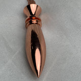 Vertical angled shot of the pointed tip and mirror-like surface, classic witchcraft pendulum look in warm copper