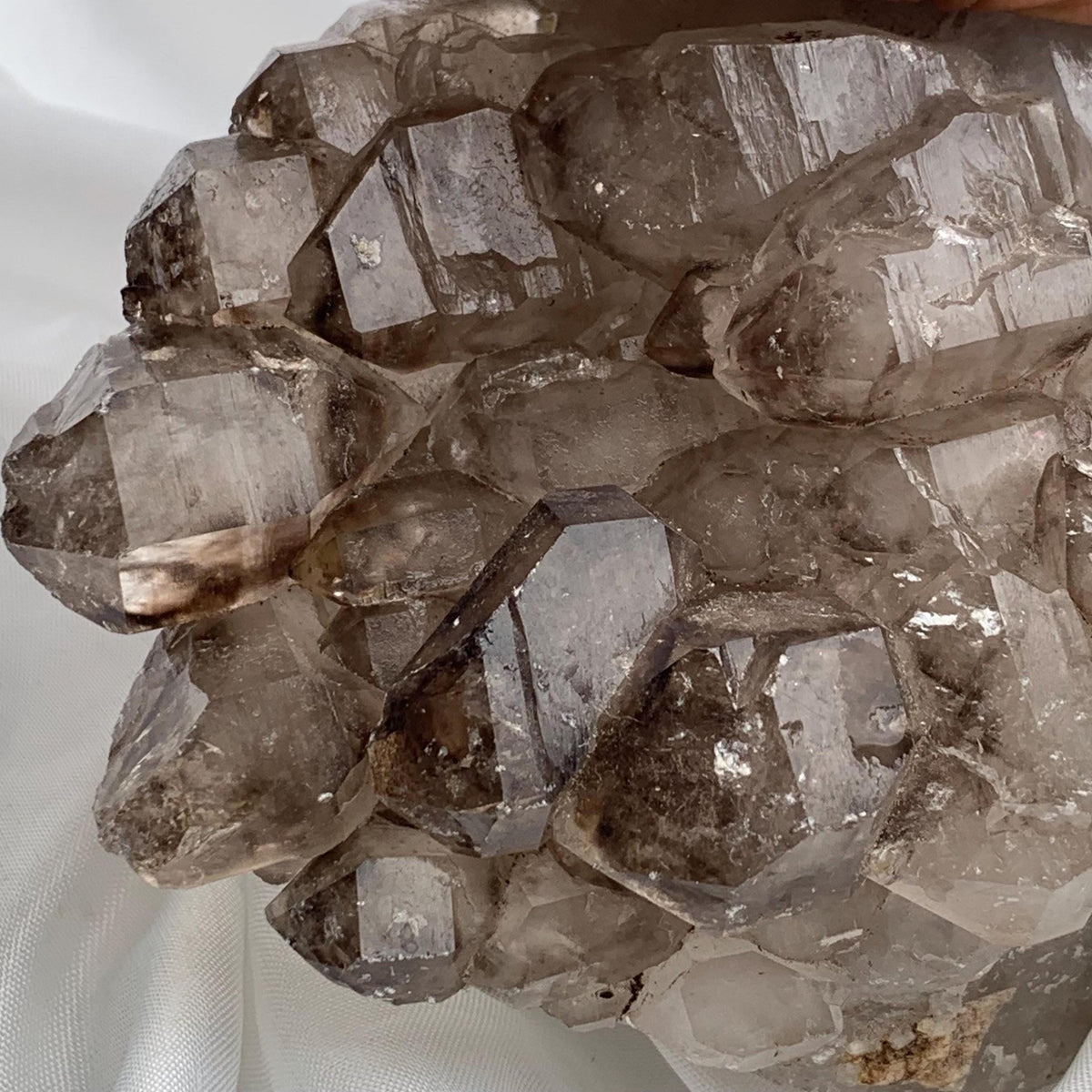 Flat-top perspective of smoky quartz gwindel cluster, many small terminations creating a textured, sculptural surface