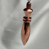 Angled perspective showing chain attachment and slender spindle, a spiritual pendulum for energy work and scrying
