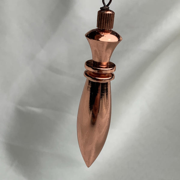 Angled perspective showing chain attachment and slender spindle, a spiritual pendulum for energy work and scrying