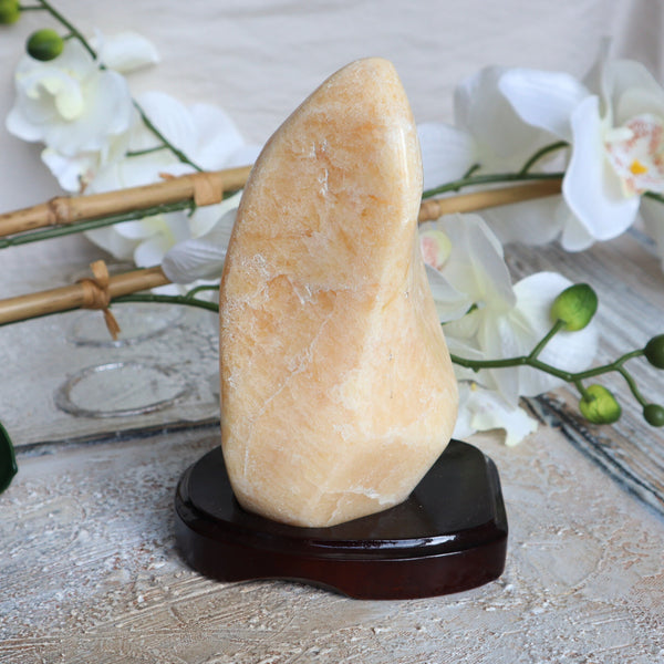 Large Orange Calcite Stone free form on wooden stand for home decor and Positive Energy