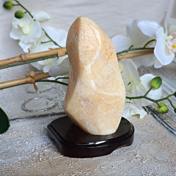 Large Orange Calcite Stone free form on wooden stand for home decor and Positive Energy